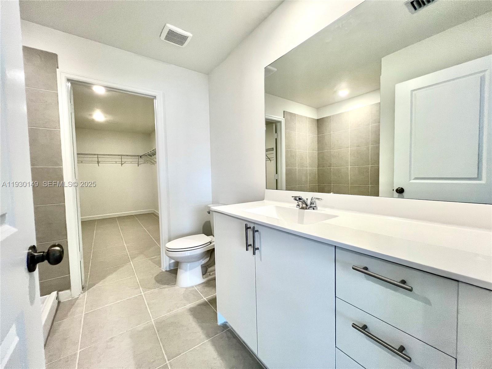 17376 Southwest 285th Street, Unit 1 Homestead, FL 33030 - Photo 16 of 32 a bathroom with a double vanity sink toilet and shower