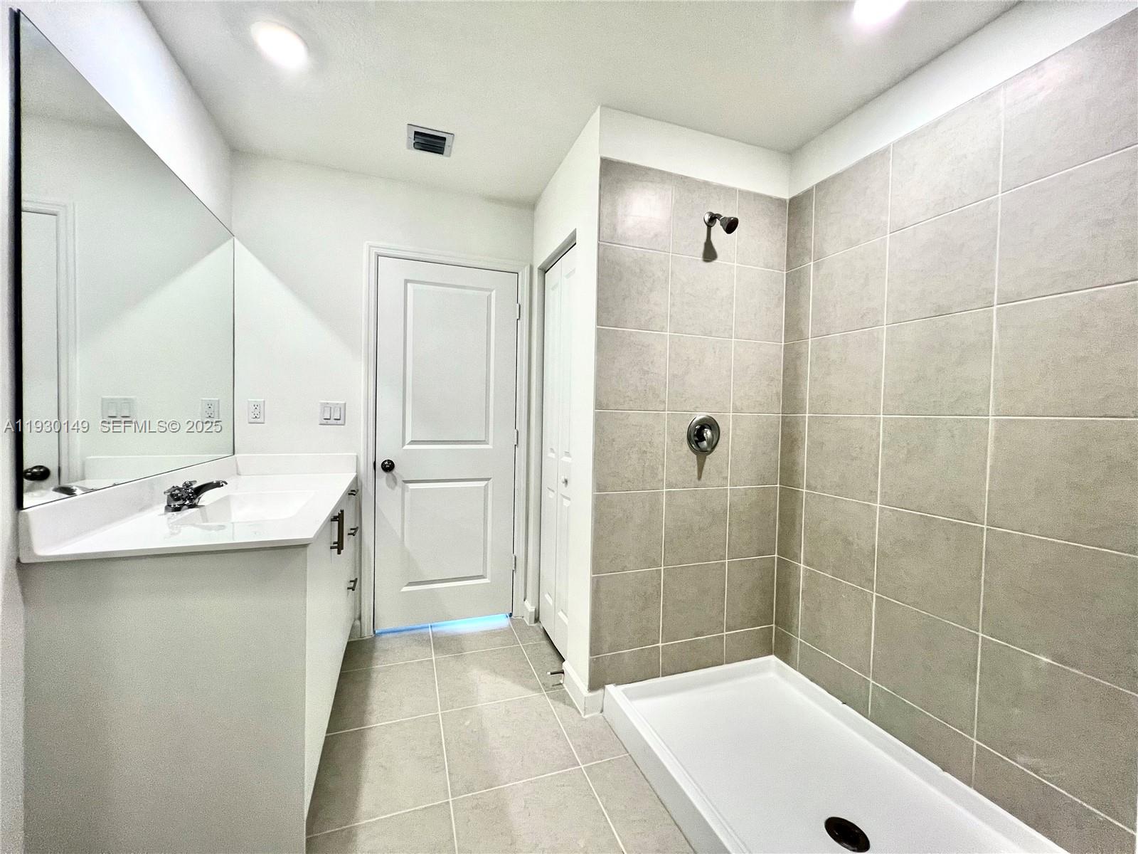 17376 Southwest 285th Street, Unit 1 Homestead, FL 33030 - Photo 17 of 32 a bathroom with a tub a sink and mirror