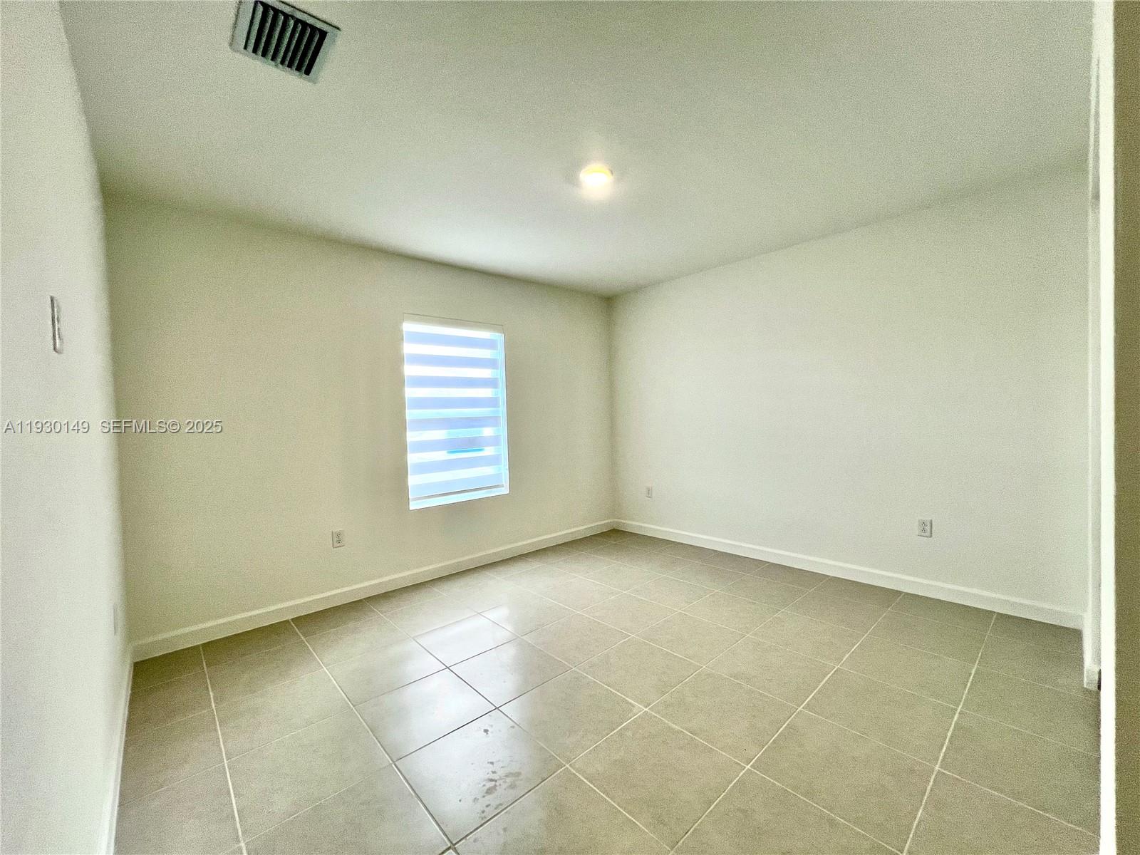 17376 Southwest 285th Street, Unit 1 Homestead, FL 33030 - Photo 20 of 32 a view of an empty room with a window