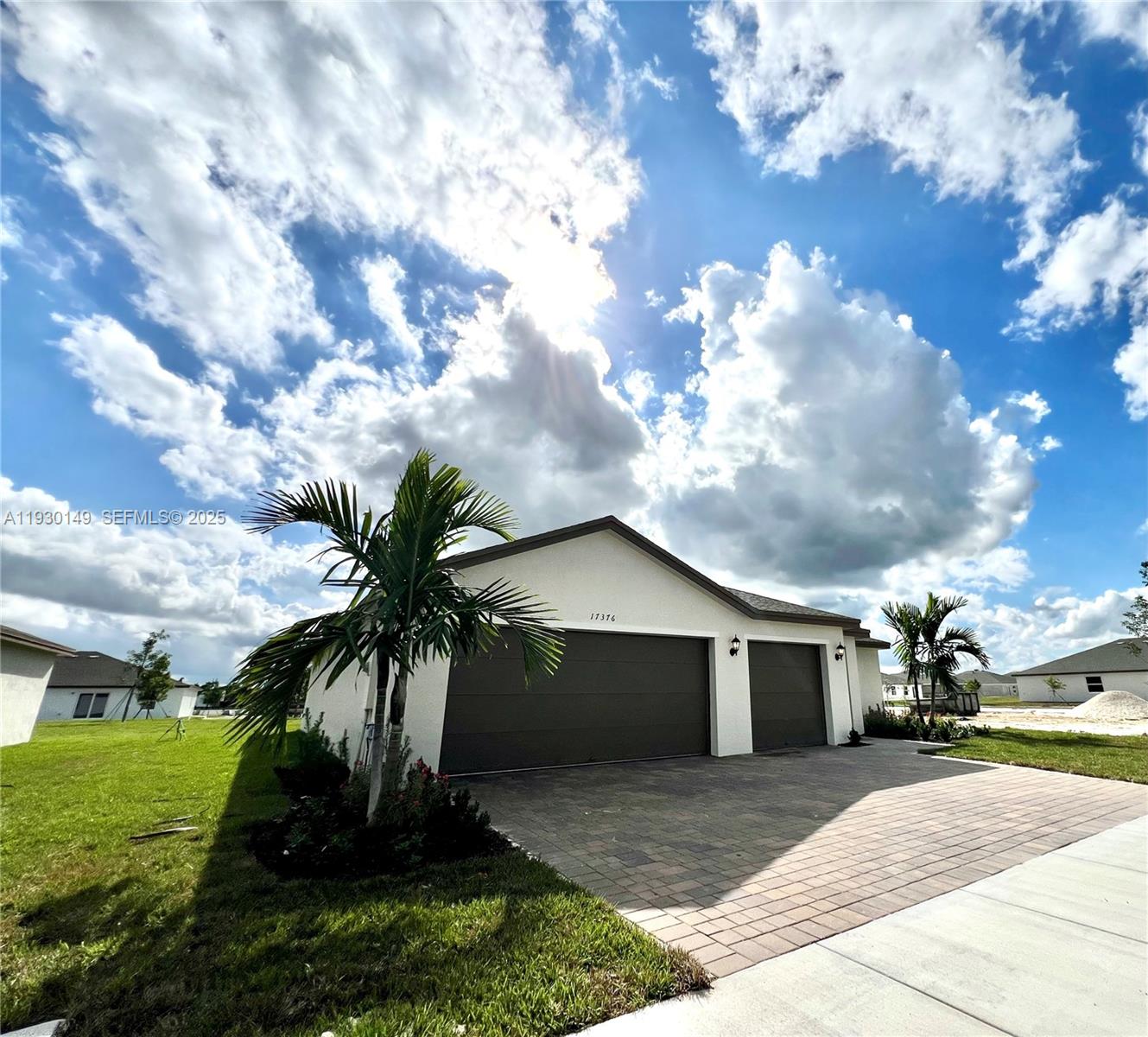 17376 Southwest 285th Street, Unit 1 Homestead, FL 33030 - Photo 2 of 32 a front view of a house with garden