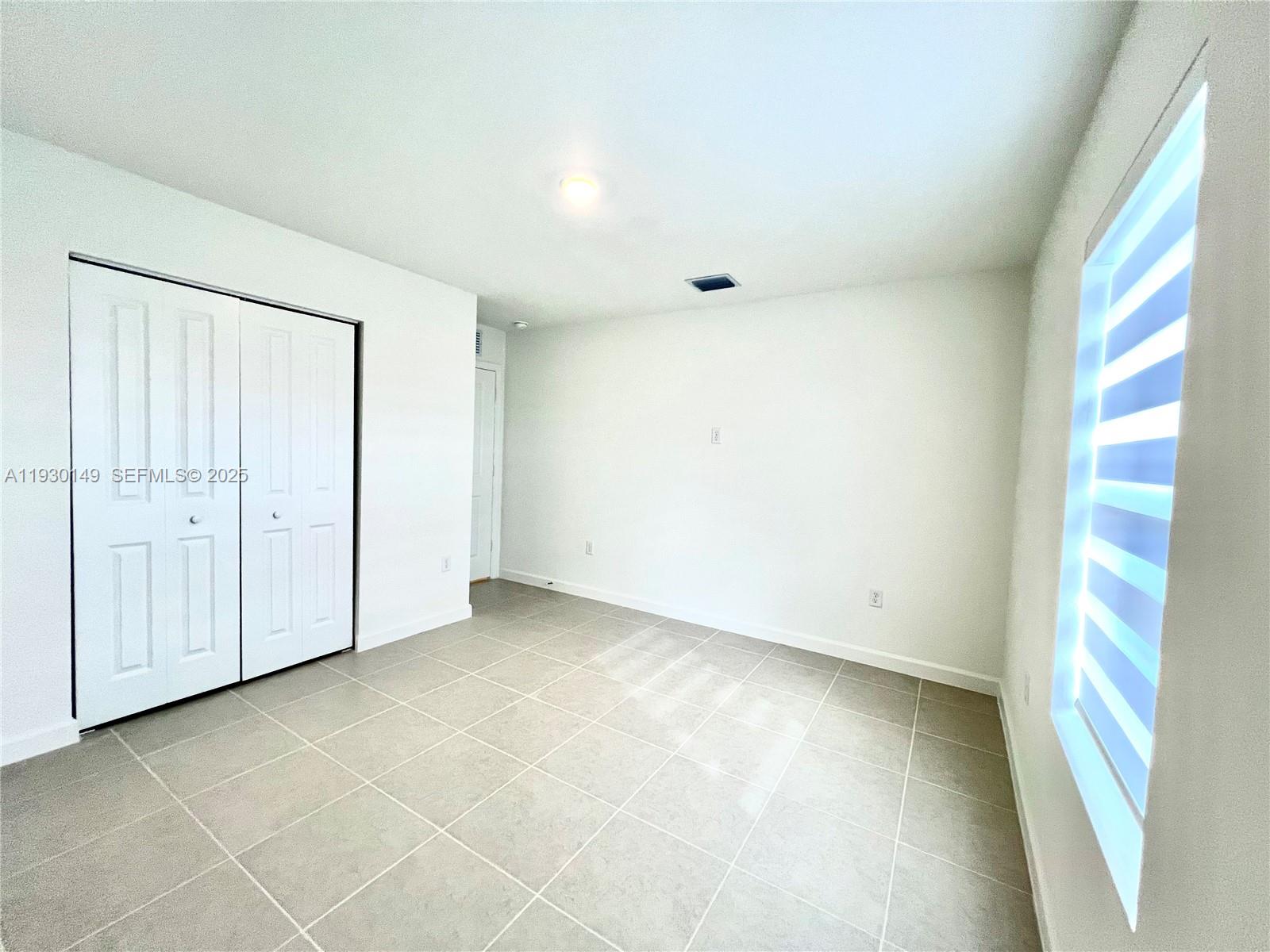 17376 Southwest 285th Street, Unit 1 Homestead, FL 33030 - Photo 21 of 32 an empty room with window