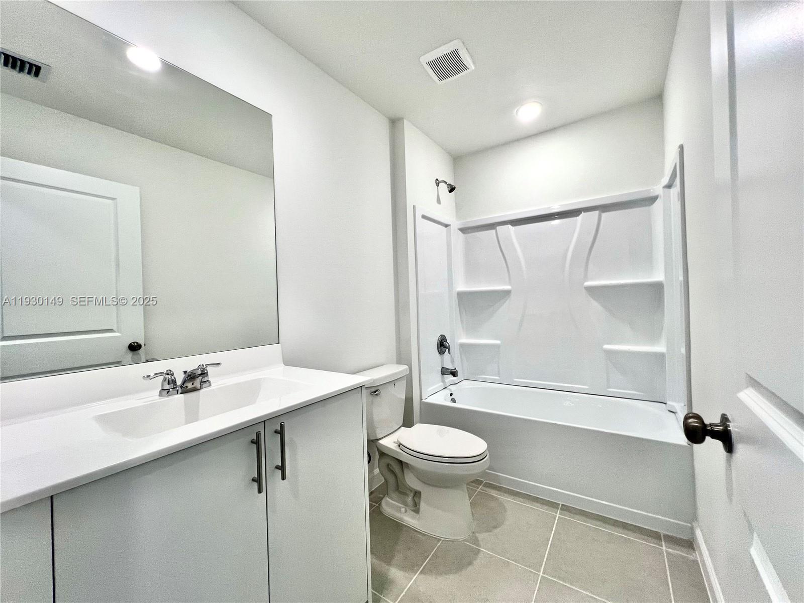 17376 Southwest 285th Street, Unit 1 Homestead, FL 33030 - Photo 22 of 32 a bathroom with a sink toilet and shower