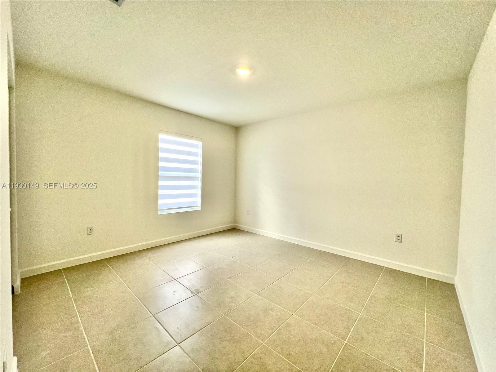 17376 Southwest 285th Street, Unit 1 Homestead, FL 33030 - Photo 23 of 32 a view of an empty room with a window