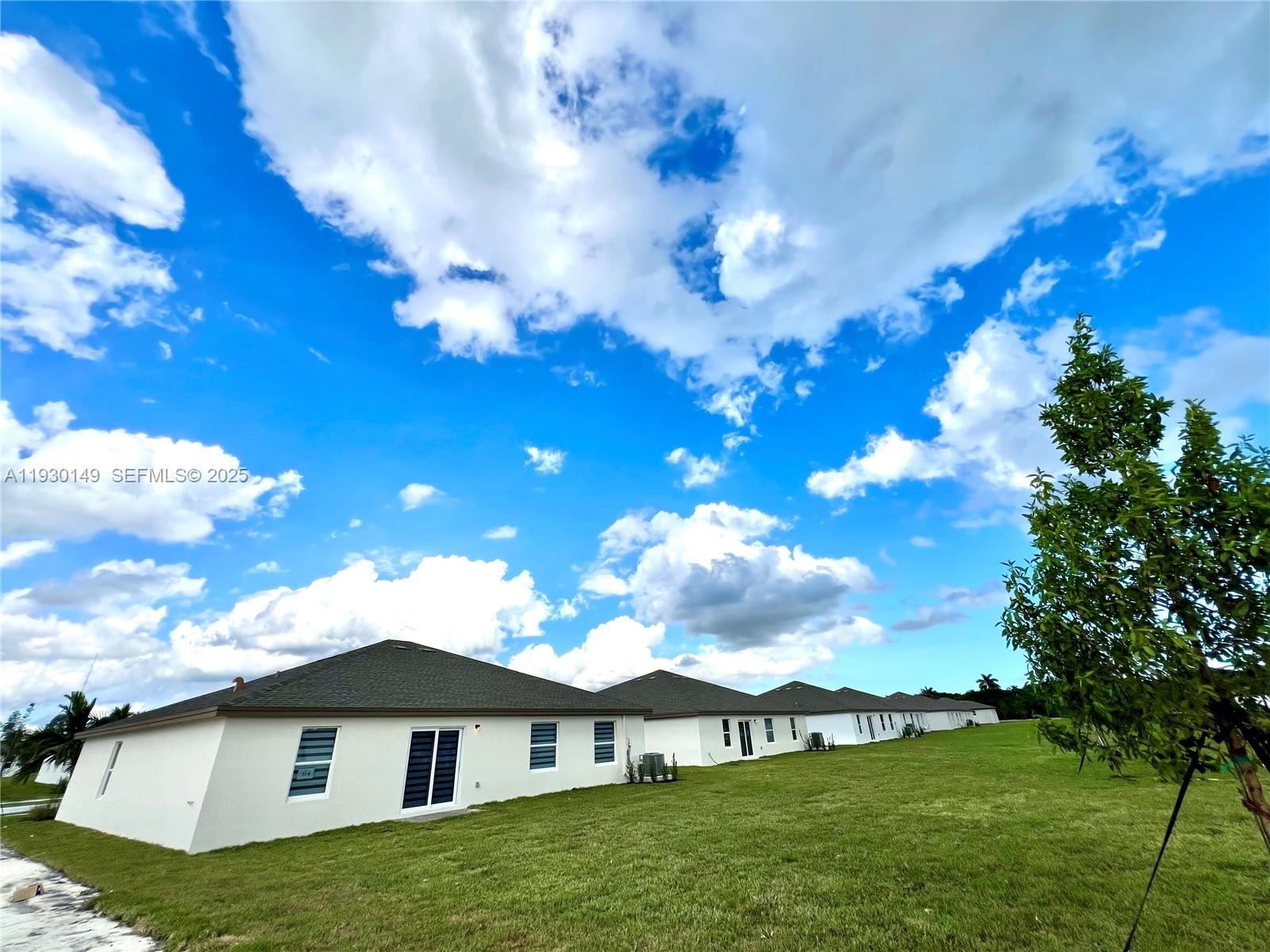 17376 Southwest 285th Street, Unit 1 Homestead, FL 33030 - Photo 29 of 32 a view of a house with a yard