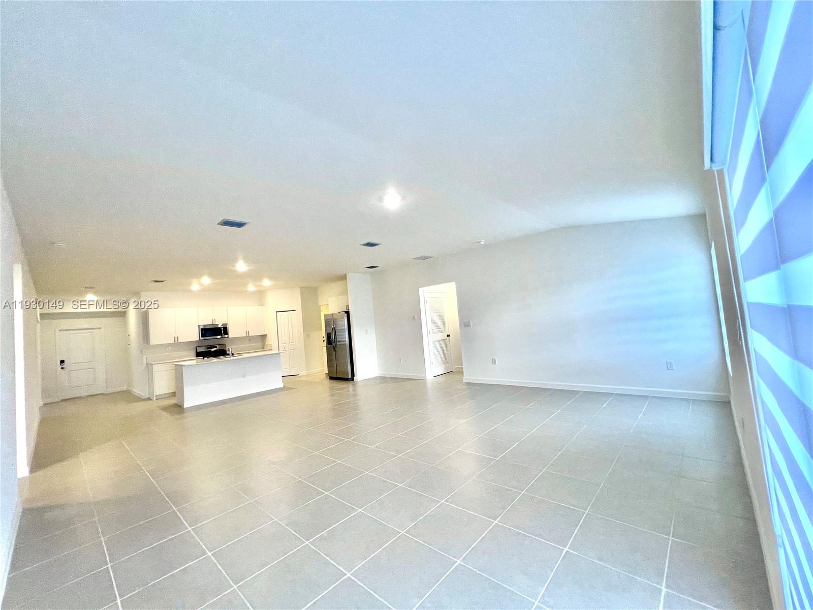 17376 Southwest 285th Street, Unit 1 Homestead, FL 33030 - Photo 7 of 32 a view of a big room with kitchen and windows