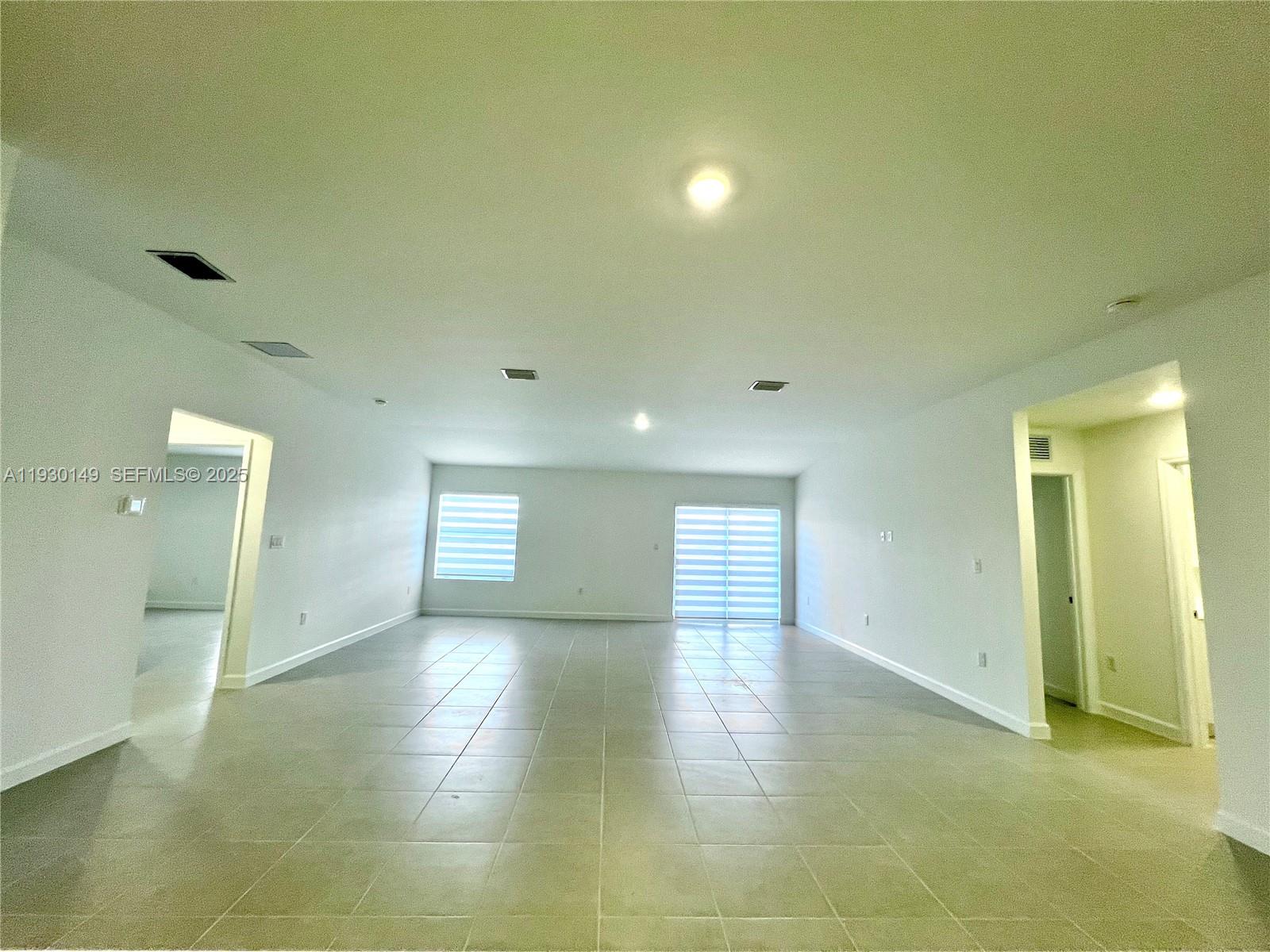 17376 Southwest 285th Street, Unit 1 Homestead, FL 33030 - Photo 10 of 32 a view of empty room and window