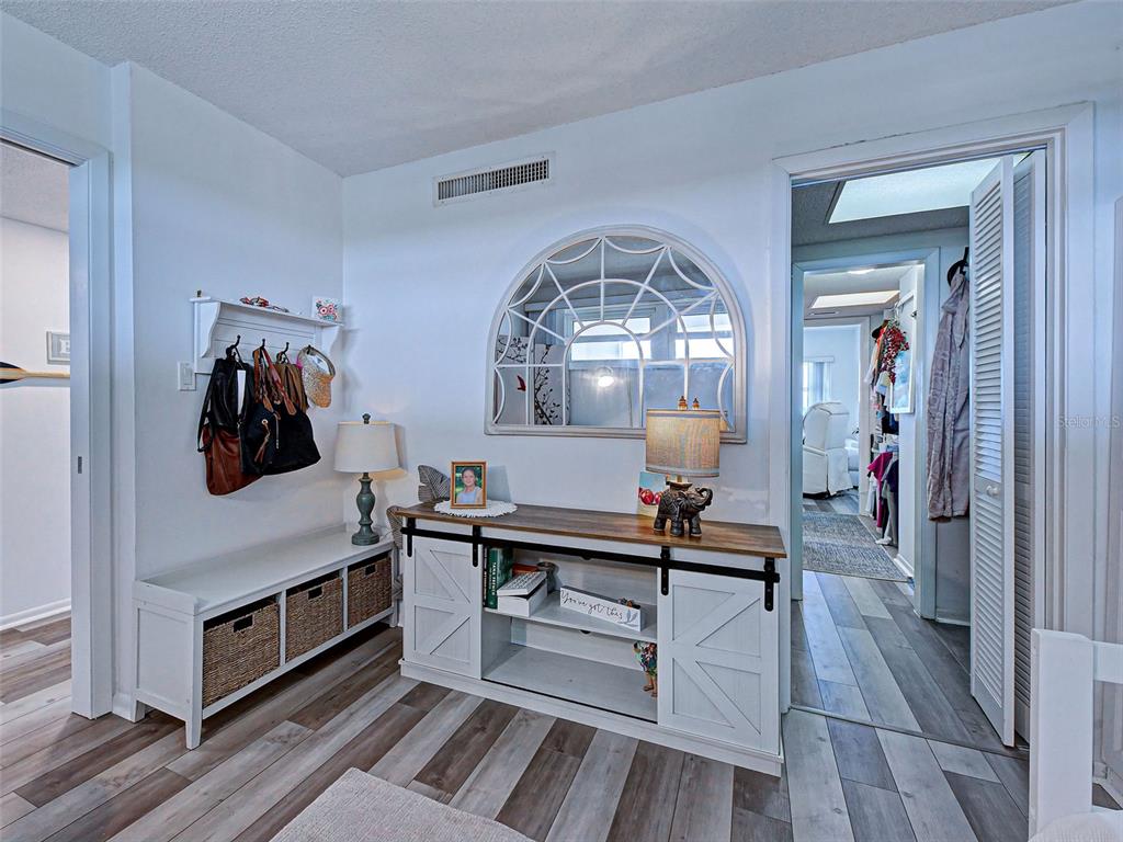 633 Alhambra Road, Unit 1006 Venice, FL 34285 - Photo 25 of 55 a living room with furniture and a chandelier