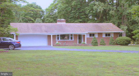 5218 Forge Road Perry Hall, MD 21128 - Photo 16 of 22 a front view of a house with a yard and trees