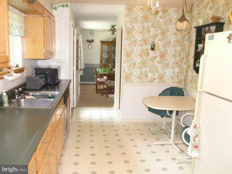 5218 Forge Road Perry Hall, MD 21128 - Photo 18 of 22 a view of a kitchen area with furniture and wooden floor