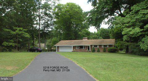 5218 Forge Road Perry Hall, MD 21128 - Photo 22 of 22 a view of a white house with a big yard and large trees