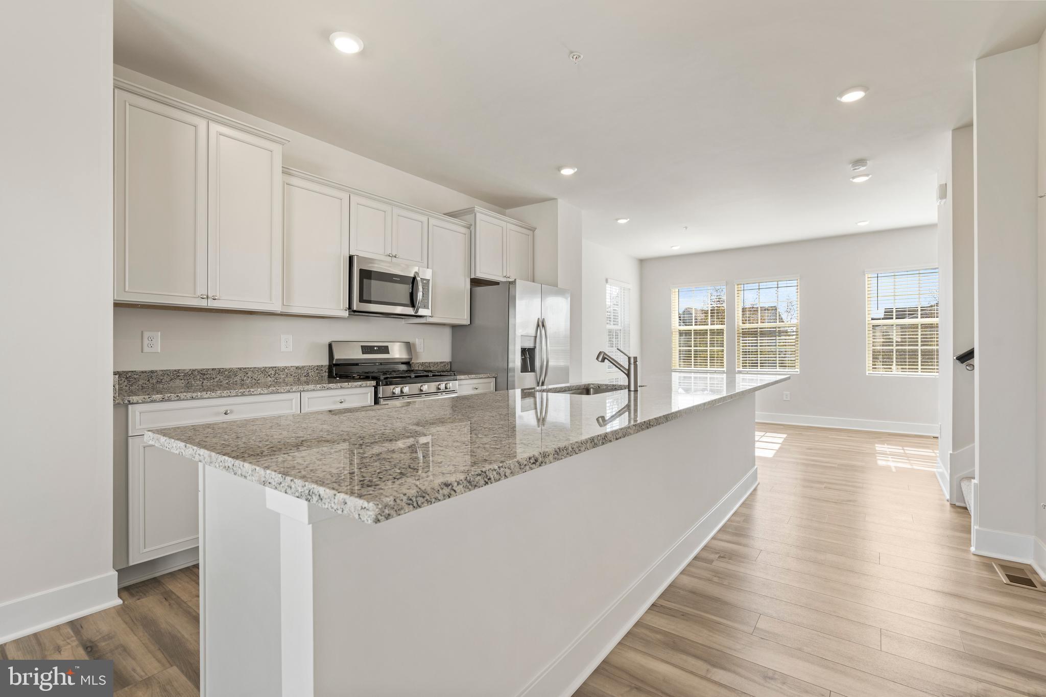 7550 Johnnycake Road Windsor Mill, MD 21244 - Photo 13 of 36 a kitchen with granite countertop a sink a counter top space and cabinets