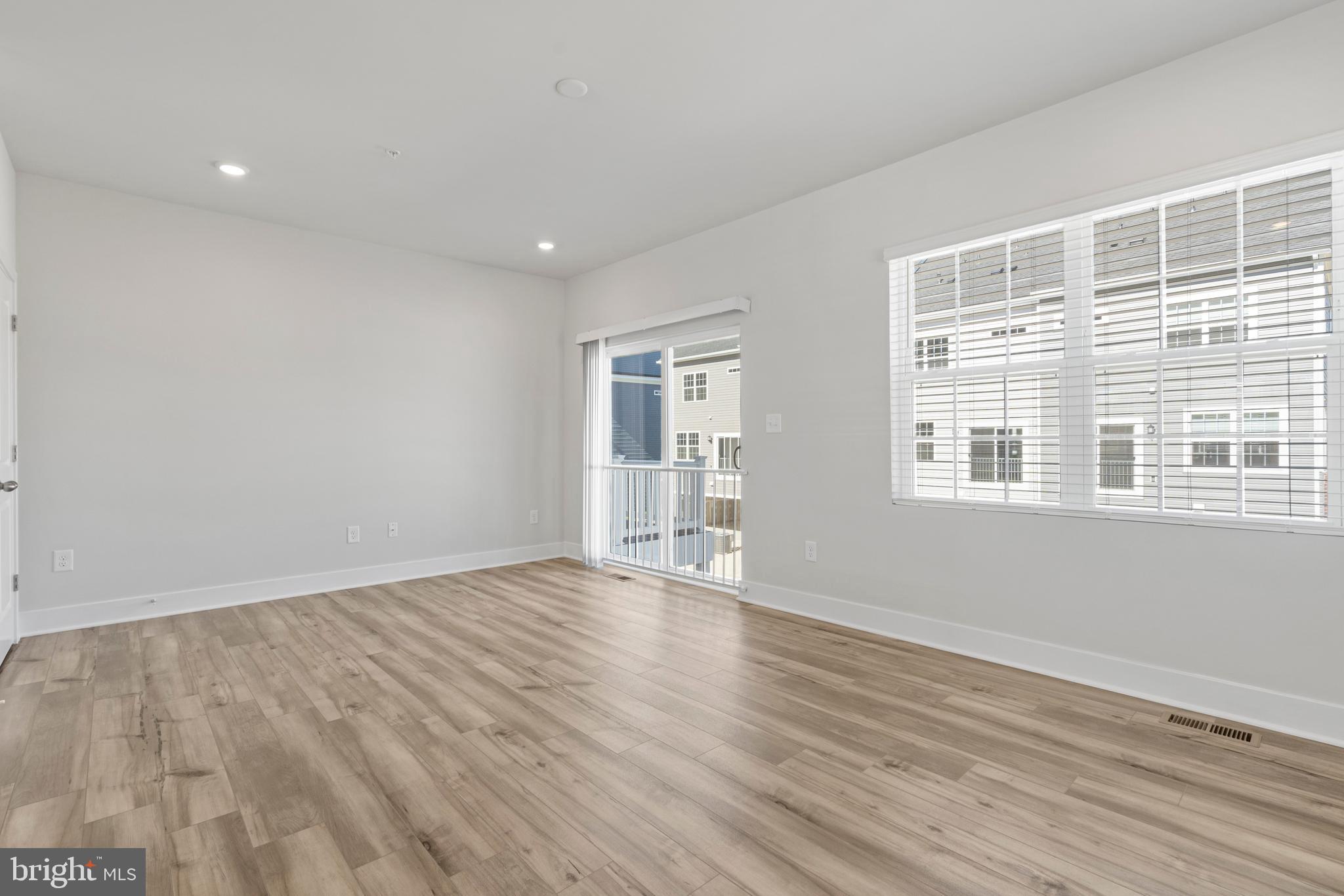 7550 Johnnycake Road Windsor Mill, MD 21244 - Photo 14 of 36 a view of an empty room with wooden floor and a window