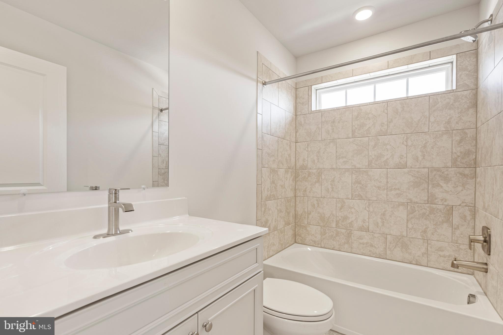 7550 Johnnycake Road Windsor Mill, MD 21244 - Photo 22 of 36 a bathroom with a sink toilet and bathtub