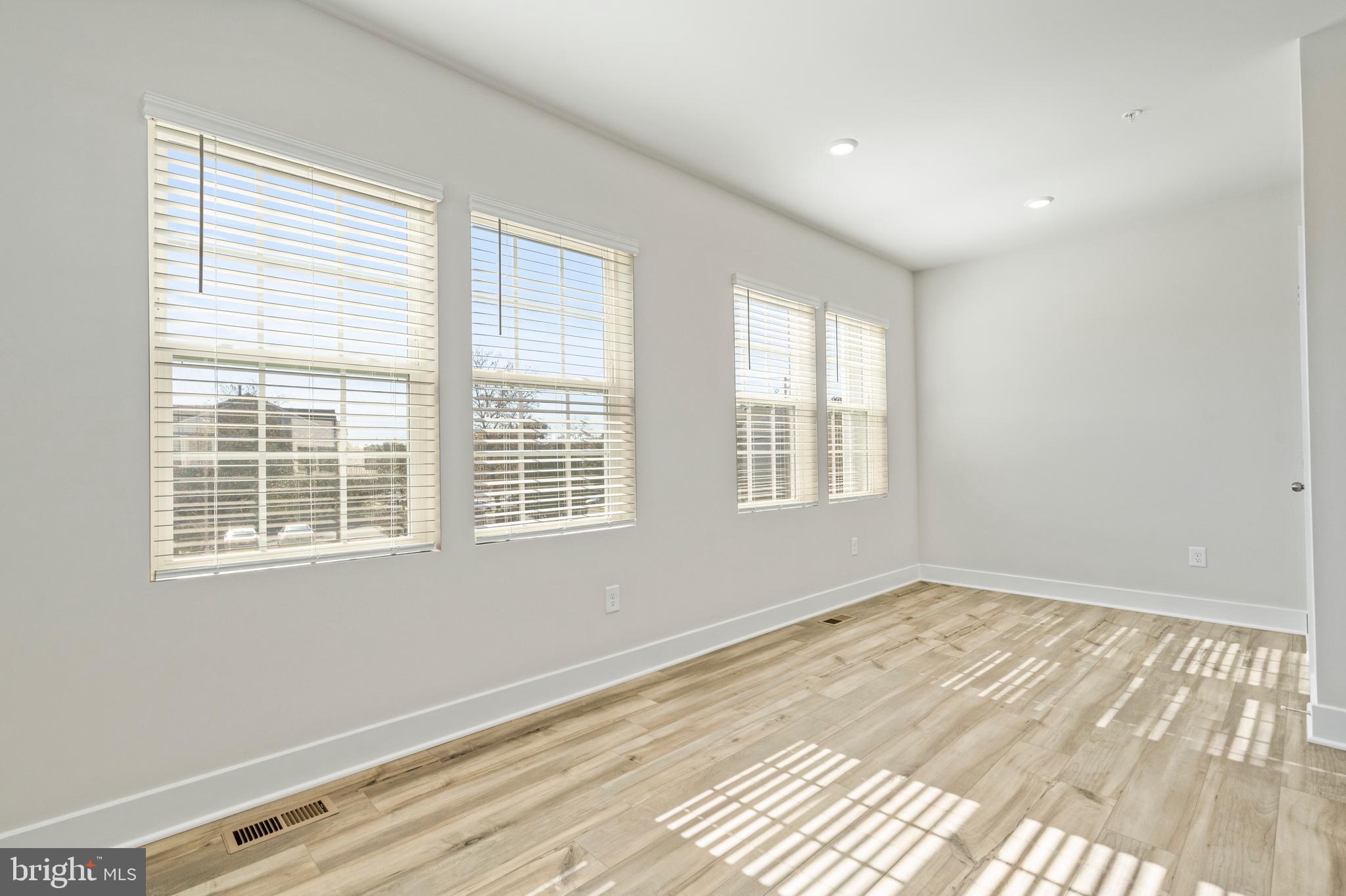 7550 Johnnycake Road Windsor Mill, MD 21244 - Photo 23 of 36 a view of an empty room with wooden floor and a window