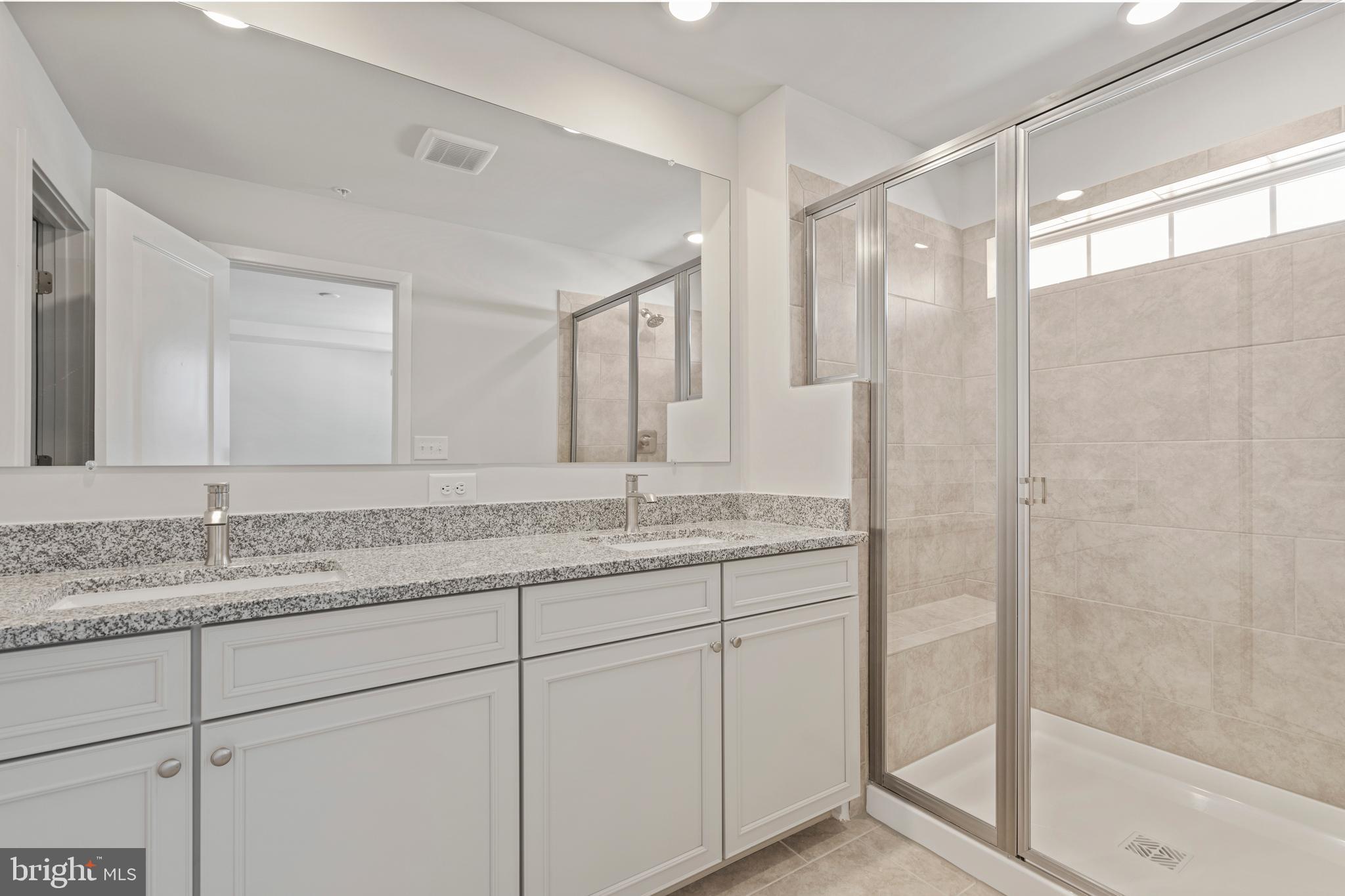 7550 Johnnycake Road Windsor Mill, MD 21244 - Photo 25 of 36 a bathroom with a granite countertop sink mirror and double