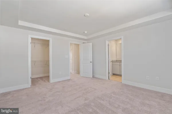 a view of an empty room and closet area