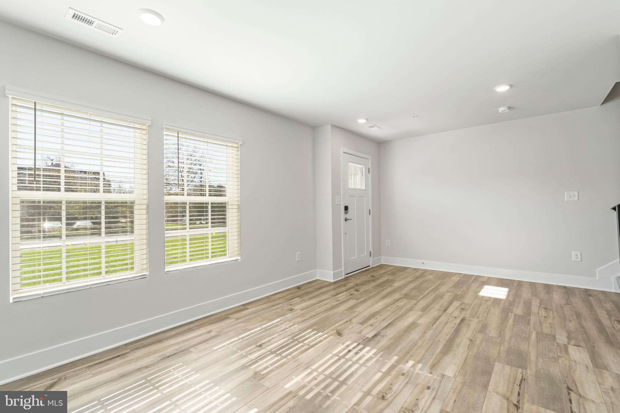 7550 Johnnycake Road Windsor Mill, MD 21244 - Photo 31 of 36 an empty room with wooden floor and windows