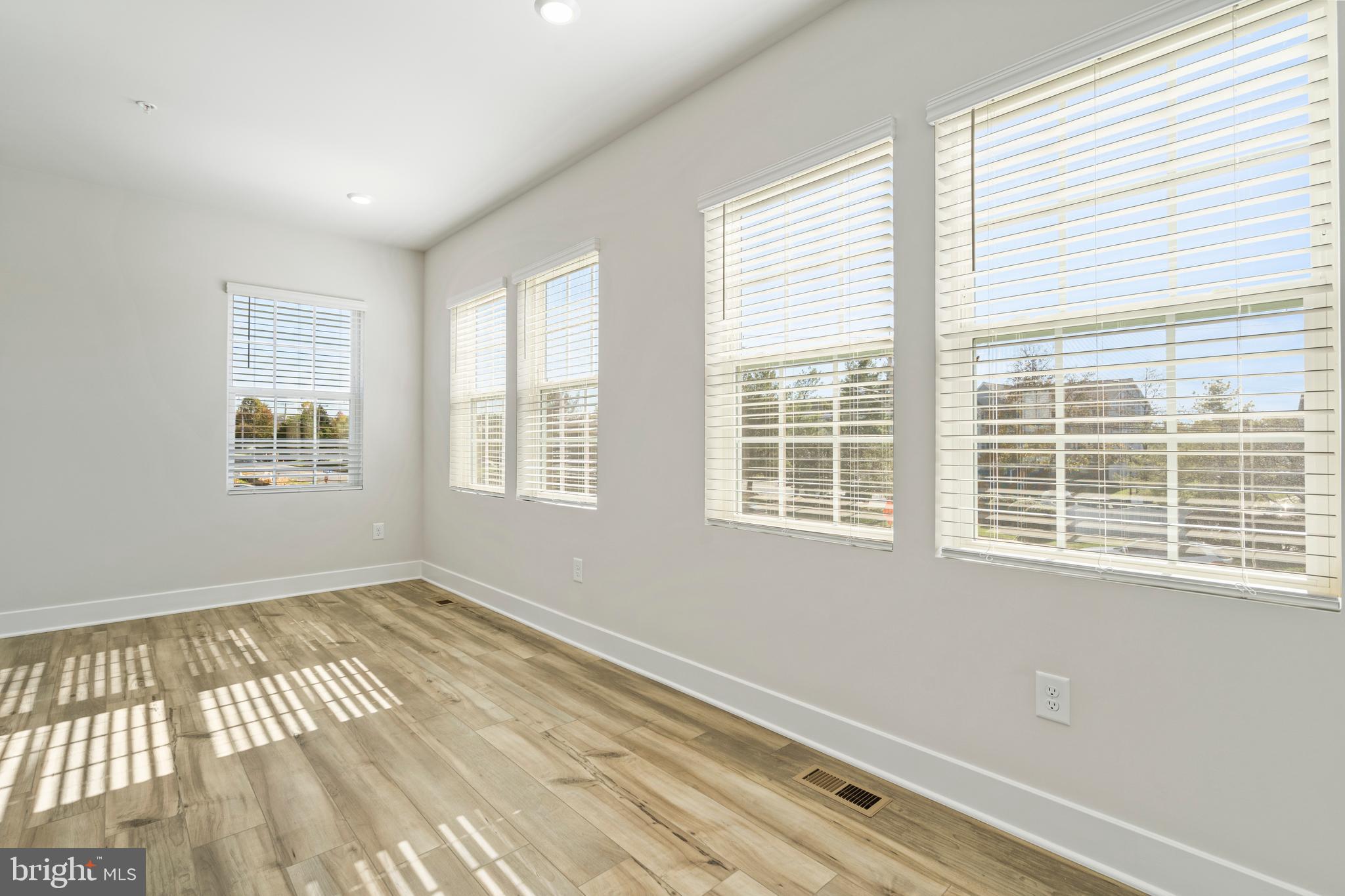 7550 Johnnycake Road Windsor Mill, MD 21244 - Photo 8 of 36 a view of an empty room with wooden floor and a window