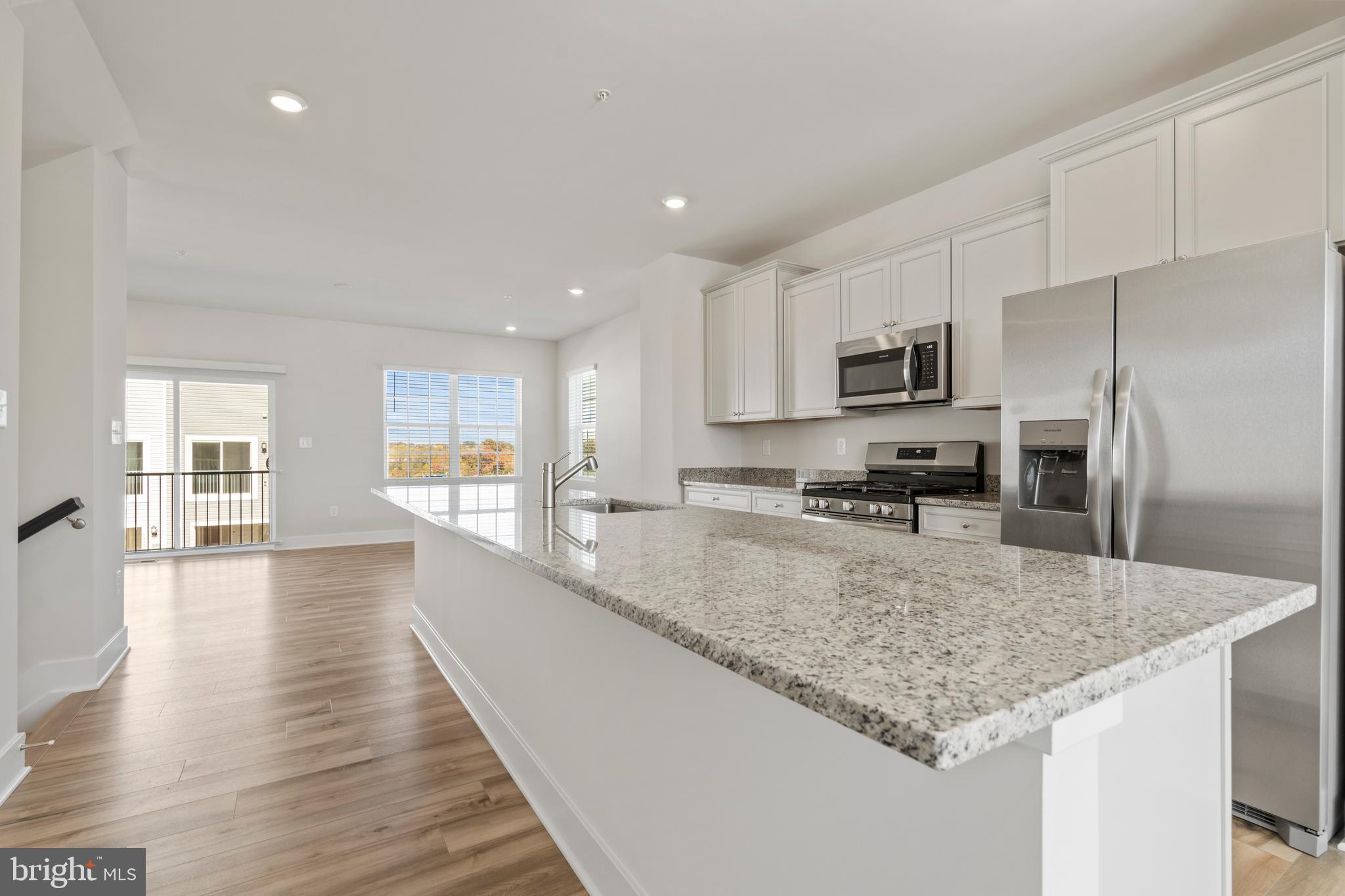7550 Johnnycake Road Windsor Mill, MD 21244 - Photo 10 of 36 a large kitchen with kitchen island a counter space a sink and appliances