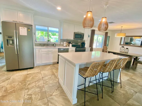 a kitchen with a table chairs and a refrigerator