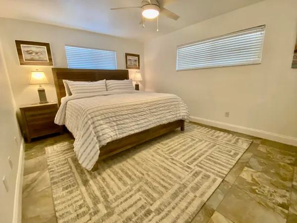 a bedroom with a bed and a night stand