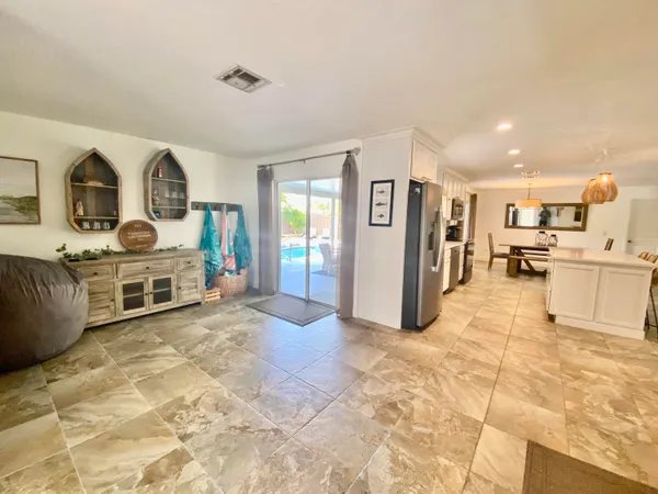 a view of a living room kitchen and a chandelier