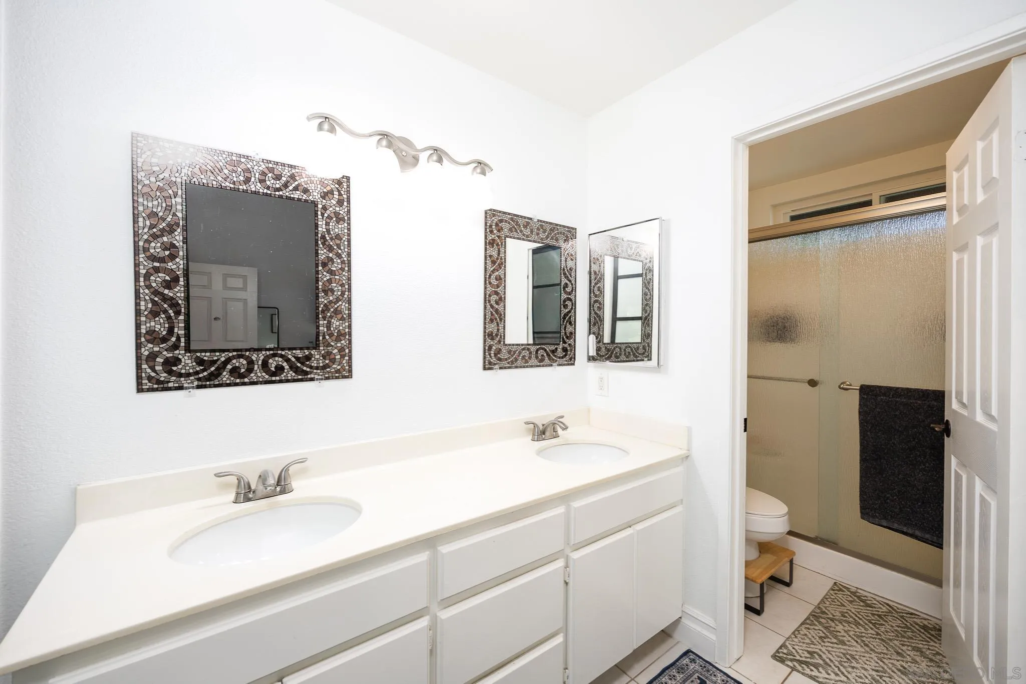 5358 Raspberry Way Oceanside, CA 92057 - Photo 14 of 31 a bathroom with a sink a toilet and shower