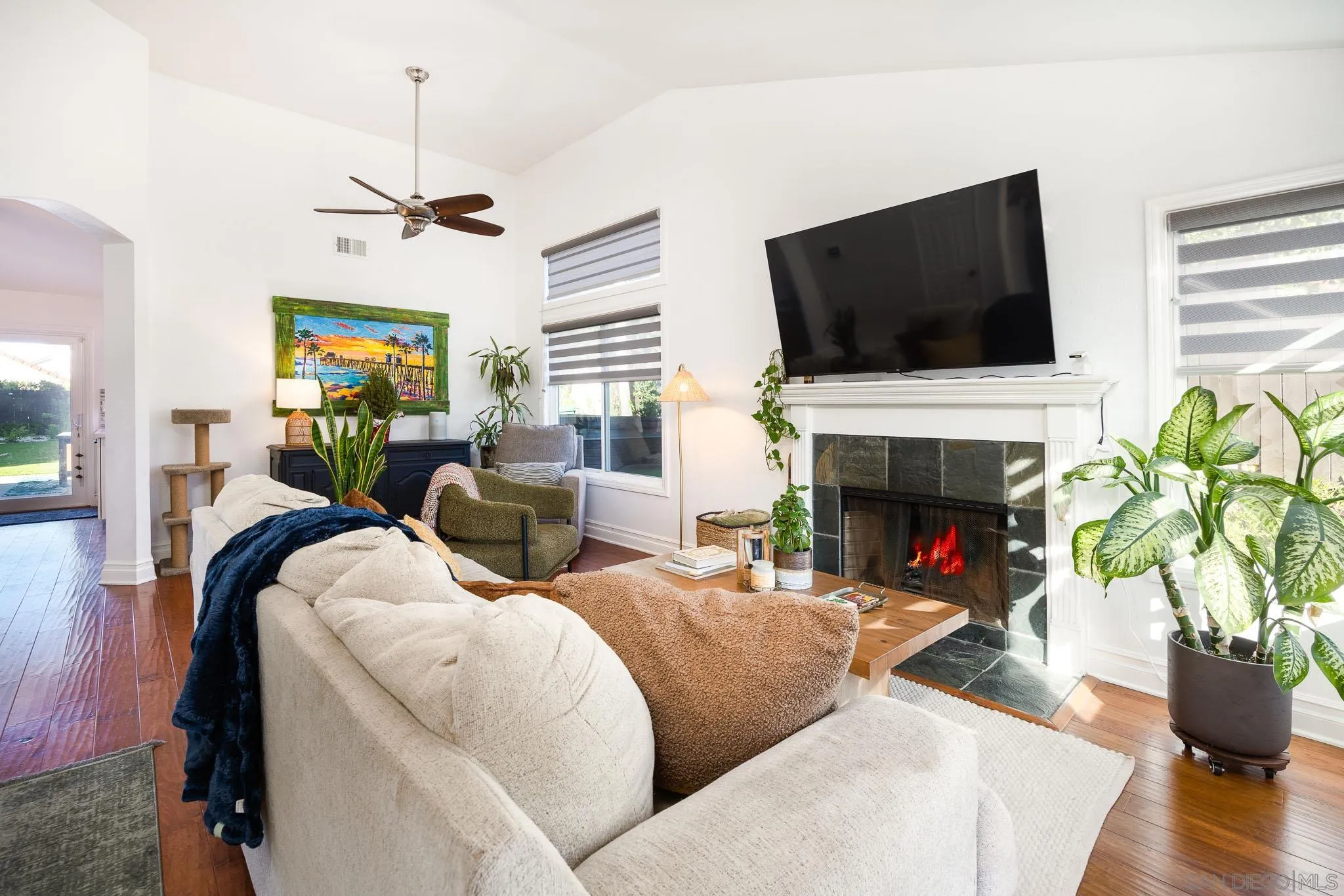 5358 Raspberry Way Oceanside, CA 92057 - Photo 2 of 31 a living room with furniture a fireplace and a flat screen tv