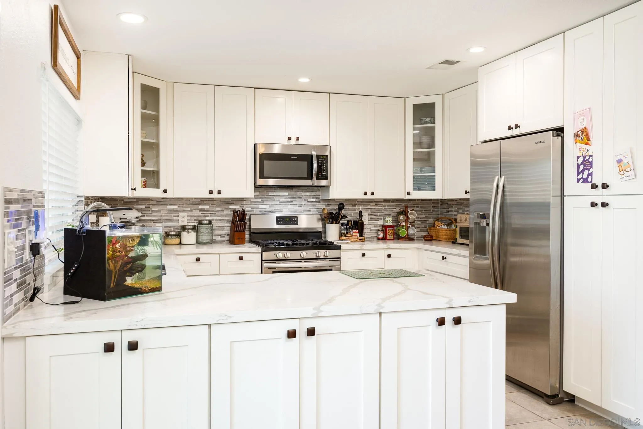 5358 Raspberry Way Oceanside, CA 92057 - Photo 8 of 31 a kitchen with refrigerator a stove a sink a counter space and cabinets