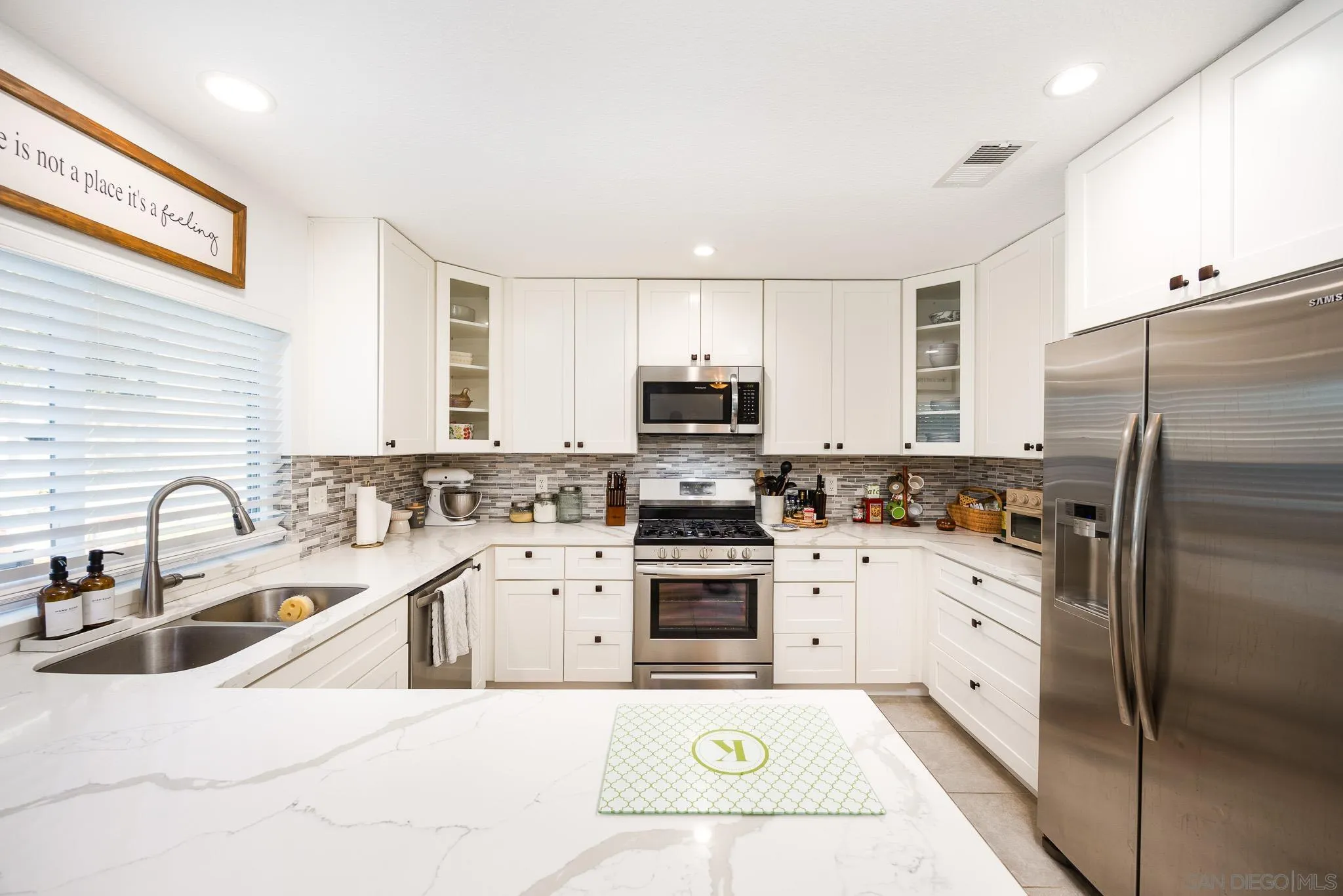 5358 Raspberry Way Oceanside, CA 92057 - Photo 9 of 31 a kitchen with a sink a stove a refrigerator and a sink
