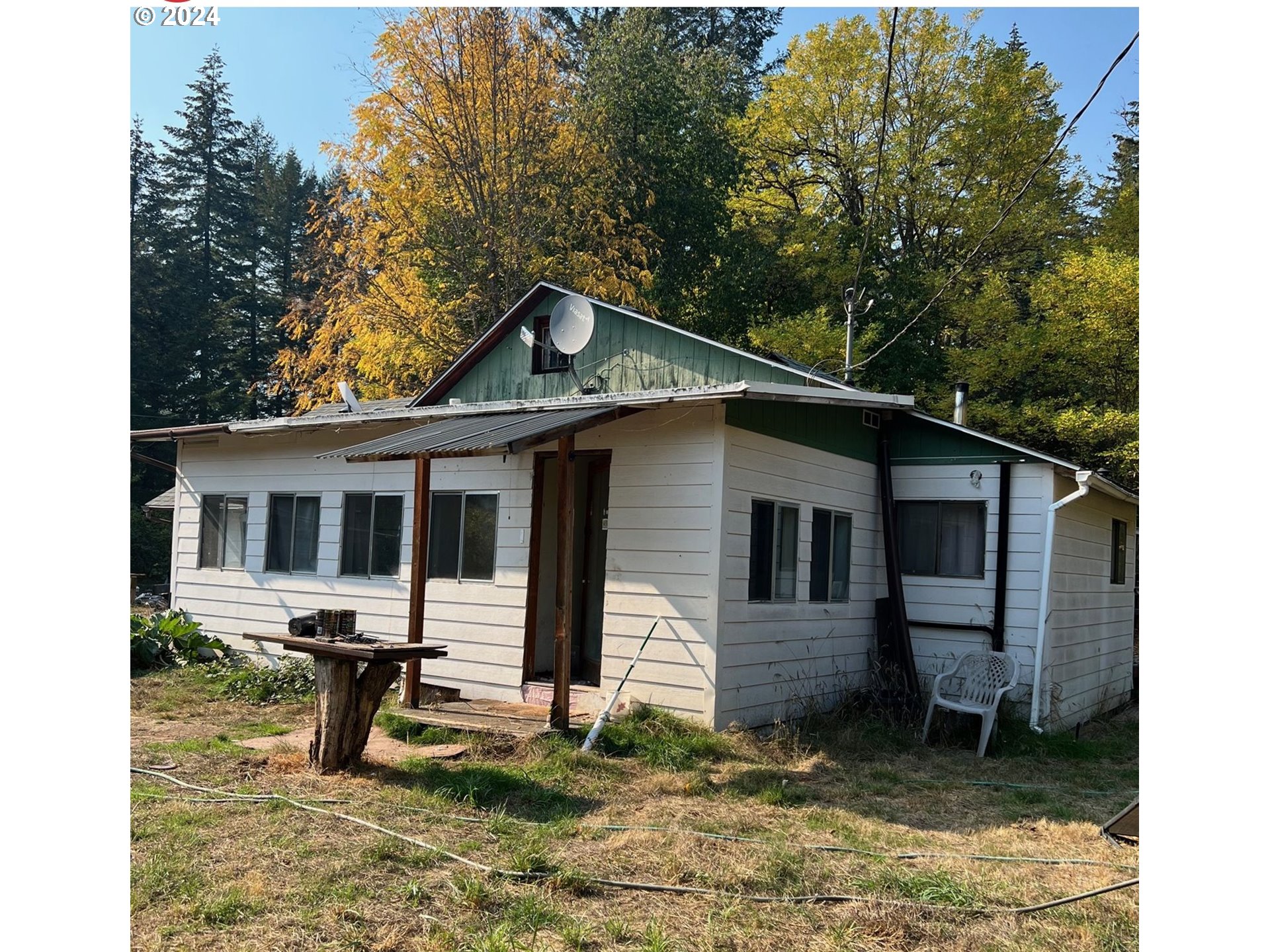 39802 Layng Creek Road Dorena, OR 97434 - Photo 2 of 6 a backyard of a house with table and chairs