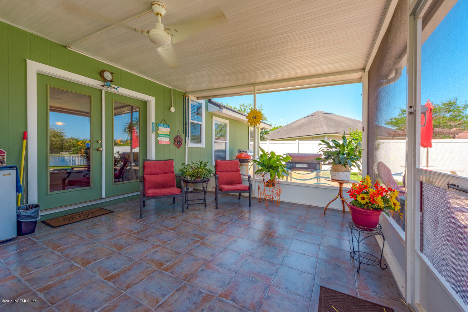 902 East Red House Branch Road St. Augustine, FL 32084 - Photo 18 of 39 a group of people sitting in patio with a dining table and chairs