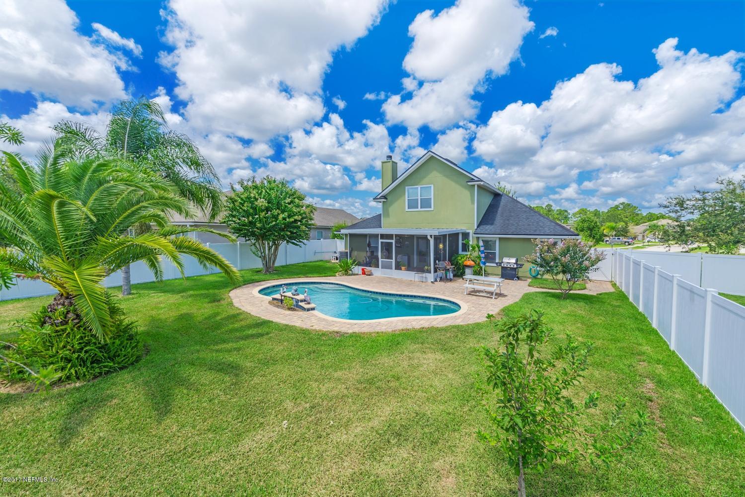 902 East Red House Branch Road St. Augustine, FL 32084 - Photo 23 of 39 a view of a house with swimming pool and a yard