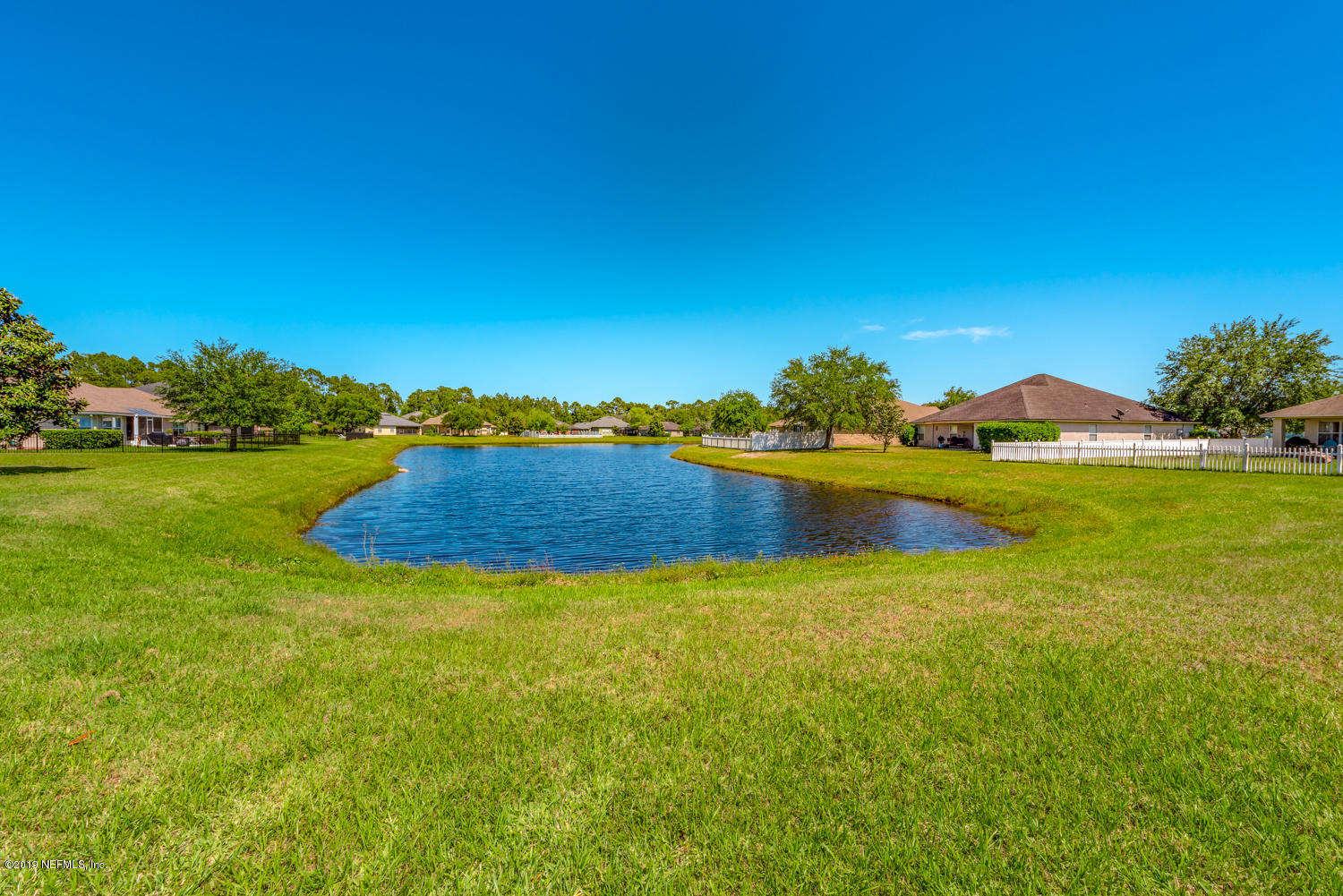 902 East Red House Branch Road St. Augustine, FL 32084 - Photo 27 of 39 a view of a lake with houses in the back
