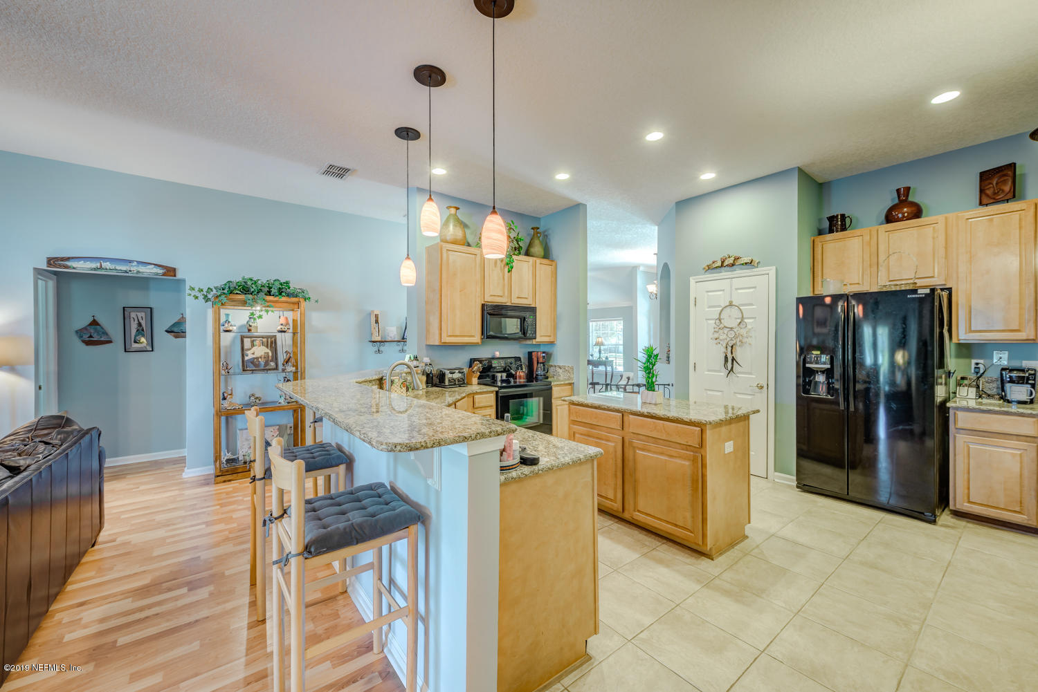 902 East Red House Branch Road St. Augustine, FL 32084 - Photo 6 of 39 a kitchen with stainless steel appliances kitchen island granite countertop refrigerator and cabinets