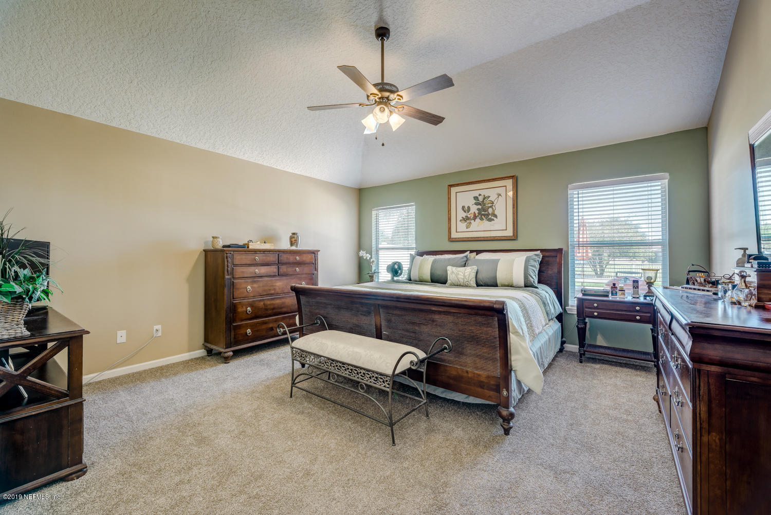 902 East Red House Branch Road St. Augustine, FL 32084 - Photo 10 of 39 a spacious bedroom with a bed and a chandelier