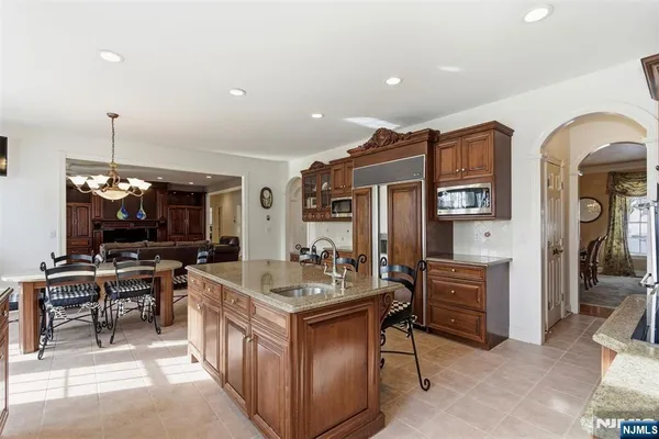 a kitchen with counter top space appliances and furniture