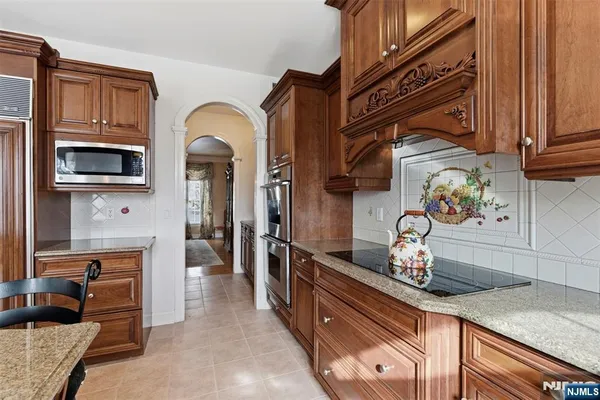 a kitchen with stainless steel appliances granite countertop a sink and cabinets