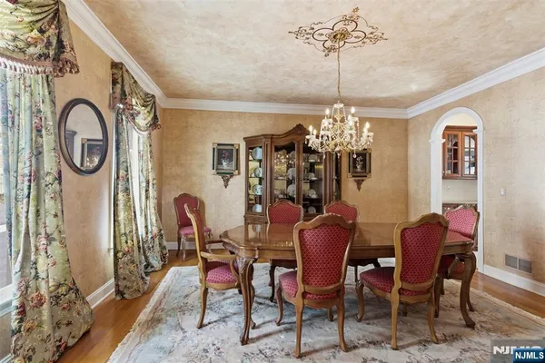a view of a dining room with furniture and chandelier