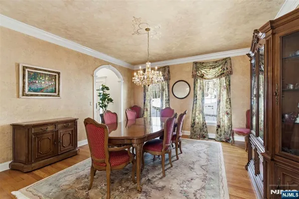 a dining room with furniture a chandelier and a rug