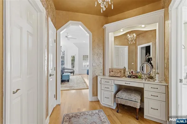 a en suite bathroom with a double vanity sink a mirror a bathtub and shower