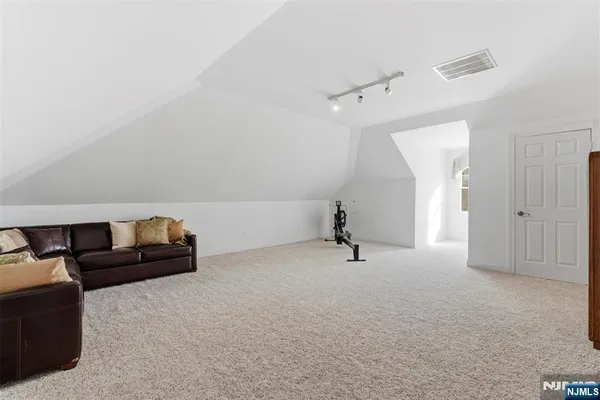 a bathroom with a granite countertop sink a toilet and shower