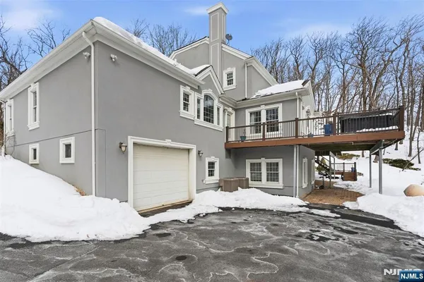 a view of a patio with couches table and chairs and wooden floor
