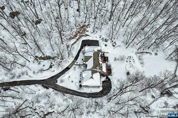 a view of house with a yard covered in snow