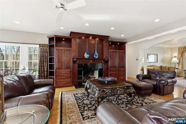 a living room with furniture a fireplace and a chandelier