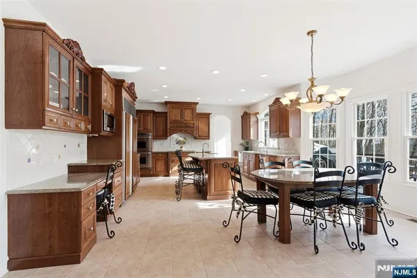 a view of a dining room with furniture and a chandelier
