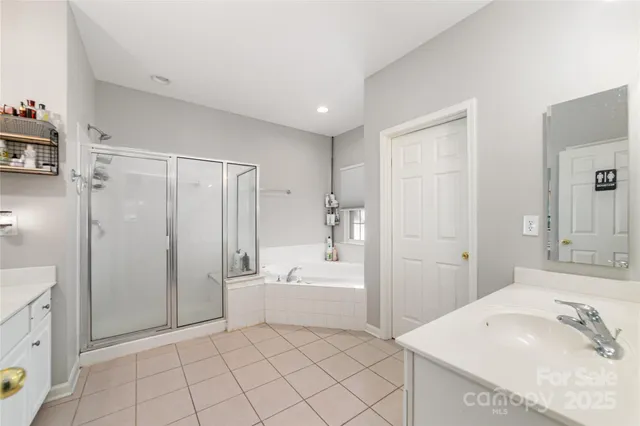 a spacious bathroom with a bathtub sink and a mirror