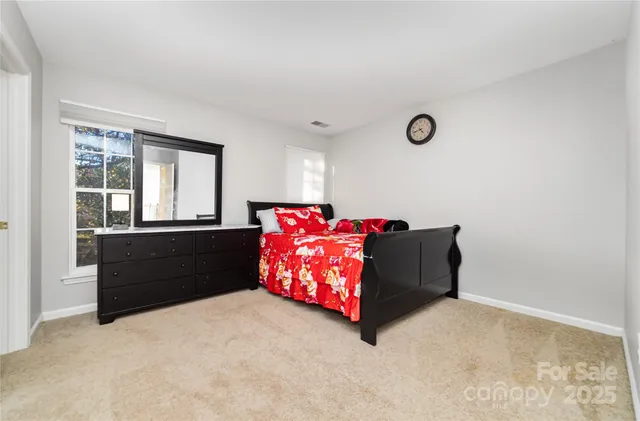 a living room with a bed and window