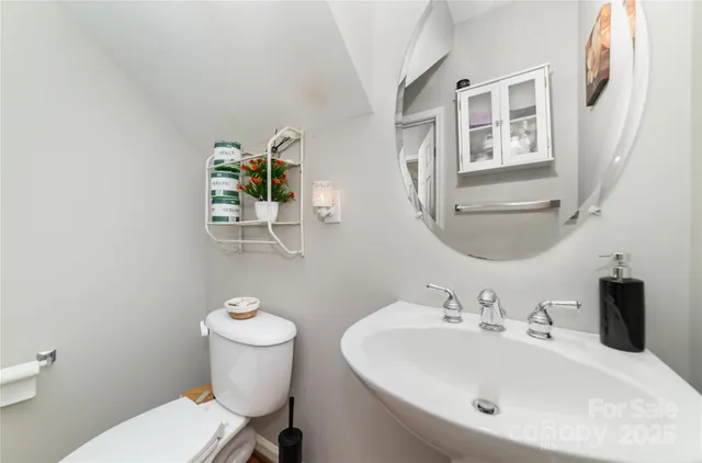 a bathroom with a sink a toilet and mirror