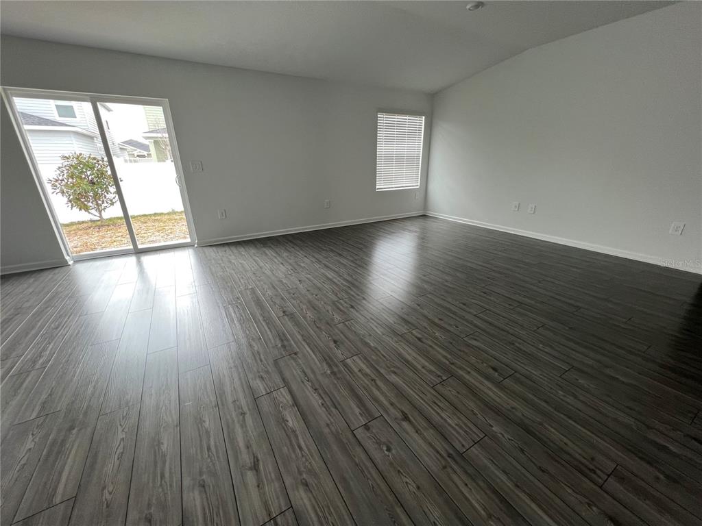 4576 Southwest 84th St Road Ocala, FL 34476 - Photo 11 of 50 a view of an empty room with wooden floor and a window